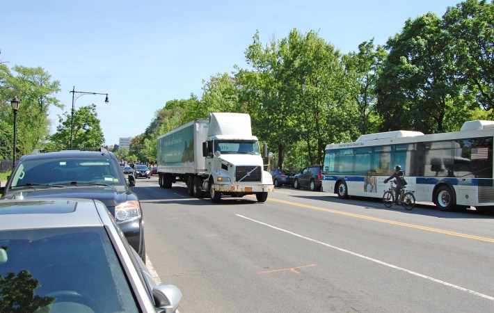 Right now, cyclists, like the man next to the bus at right, have to mix with fast-moving traffic. Photo: Isaac Blasenstein