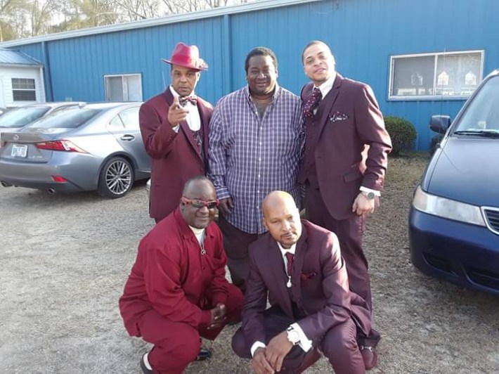 Postal Service victim Charles McClean, kneeling on the right, with his brother Arkim (also kneeling), Gregory (top left) and Reggie (center). A nephew is on the top right. Photo: McClean family.