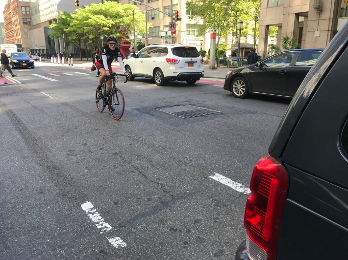 This southbound Jay Street cyclist was forced into the roadway because the protected bike lane currently ends abruptly at the Myrtle Promenade. Photo Gersh Kuntzman