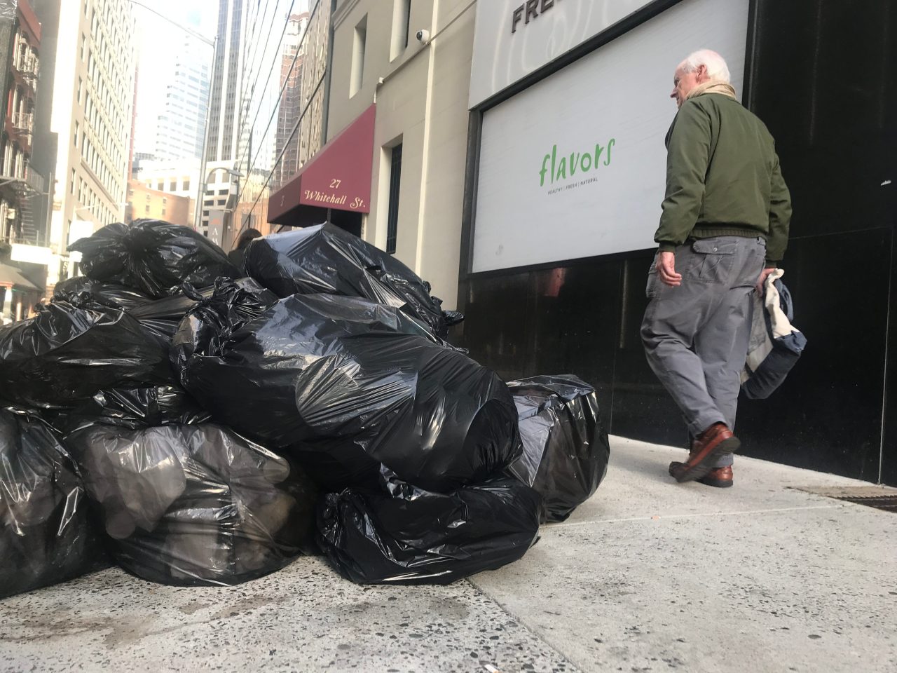 A scene that can be seen every day: a New Yorker trying to avoid a huge pile of trash on the sidewalk. File photo: Gersh Kuntzman