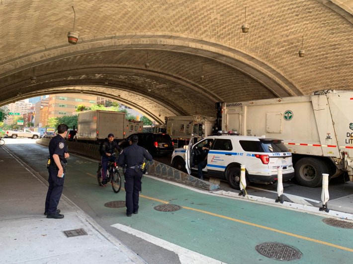 Cops from the 19th Precinct busted e-bike-riding delivery workers in a protected bike lane on Tuesday. Photo: Macartney Morris