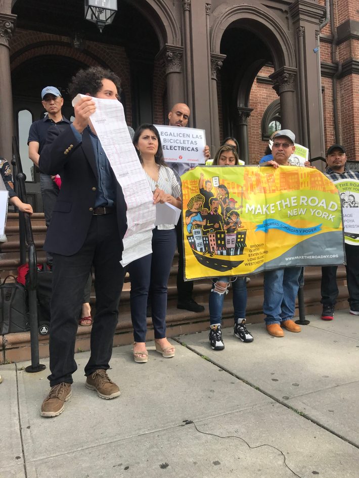 Activist Mel Gonzalez shows off the tickets received by an e-bike rider. Photo: Gersh Kuntzman