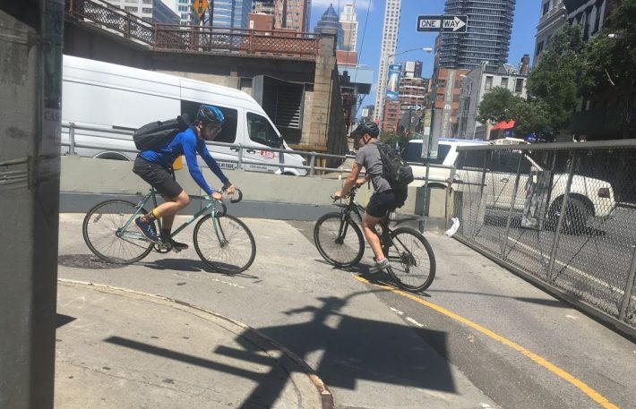 Cyclists negotiate a 180-degree turn at the base of the QBB ramp at First Avenue. The ramp has a 9-foot incline. Below, a minute-long video captures some of the dangers for cyclists on the bridge's Queens approach.Photo and video: Steve Scofield