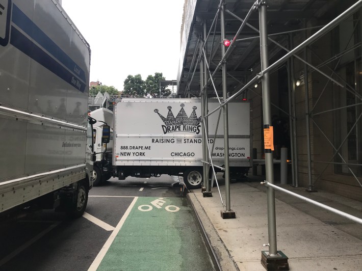 A truck parked perpendicular in the bike lane to access the loading zone. Photo: Julianne Cuba