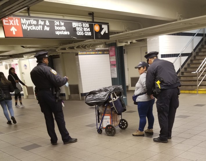 A churro vendor was placed in cuffs at a Bushwick subway station on Monday — even as another detained churro vendor was protesting her mistreatment at a rally. Photo: Rafael Martinez