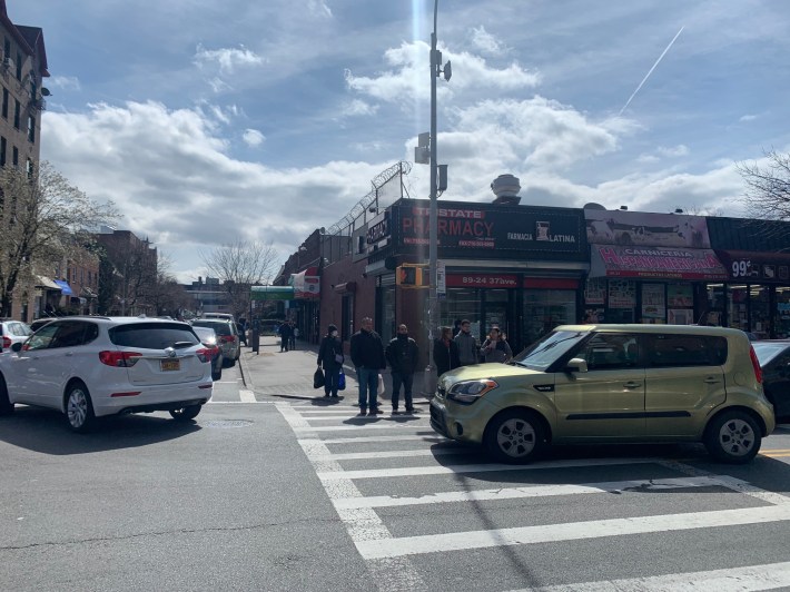 Give the people space! The crowded corner of 37th Avenue and 90th Street in Jackson Heights shows the unhealthy conditions when cars and drivers have priority over the greater public. Photo: Courtesy Nuala O'Doherty-Naranjo