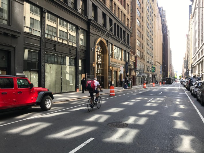 A cyclist outside the bike lane on 39th Street between Sixth Avenue and Seventh Avenue. Photo: Dave Colon