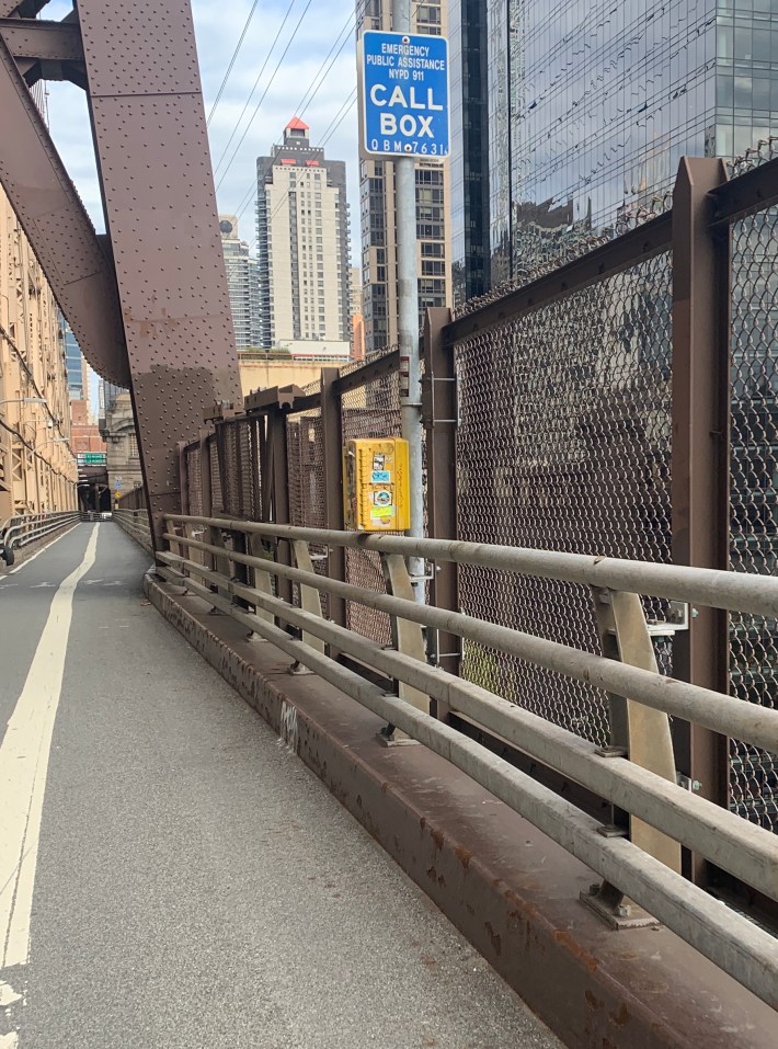 The existing fence on the north outer roadway is pretty easy to scale anyway, especially with the help of a call box. Photo: Gersh Kuntzman