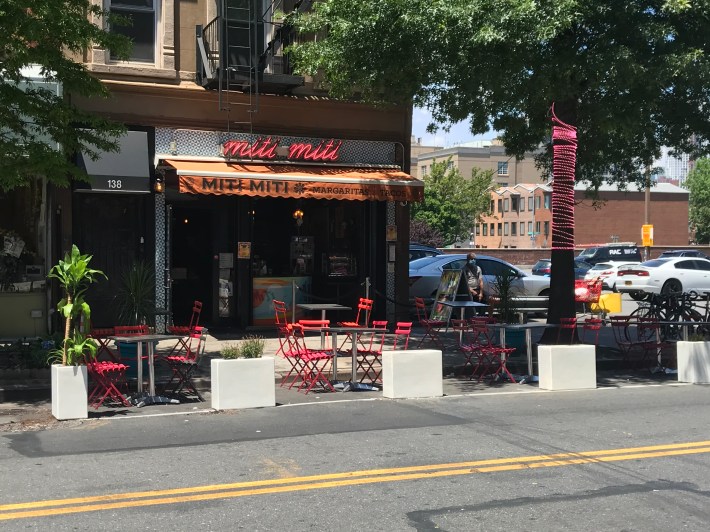 Planters protect the street seating at Miti Miti. Photo: Dave Colon