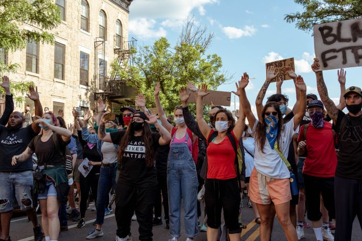 Marchers moved forward with their hands up to indicate non-violence. Photo: Kel Bush