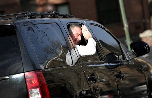 Mayor de Blasio, waving to bus riders stuck in traffic.