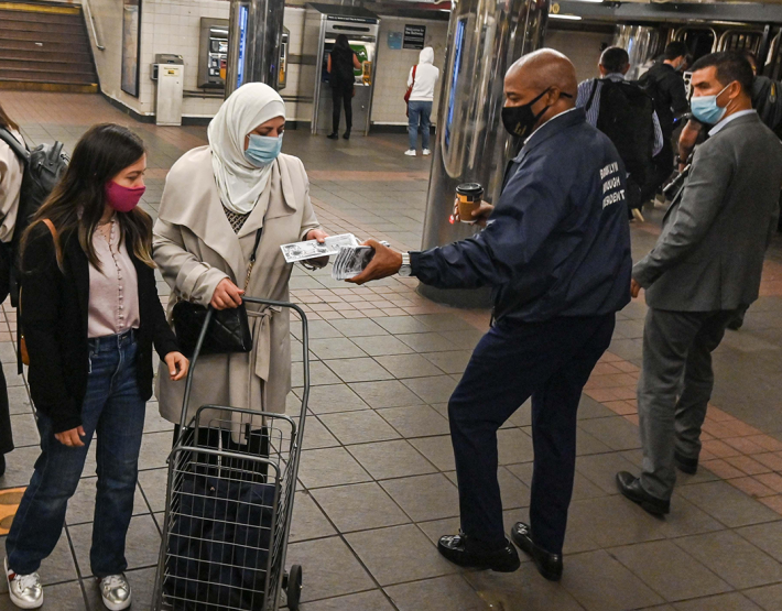 Mayoral candidate and Brooklyn Beep Eric Adams hands out literature in the subway. File Photo