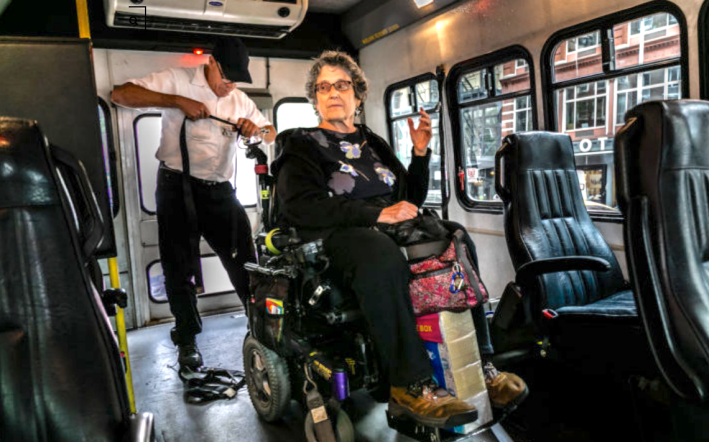 Jean Ryan of Disabled in Action waits for her wheelchair to be strapped into an Access-A-Ride van. Photo: Adi Talwar / City Limits