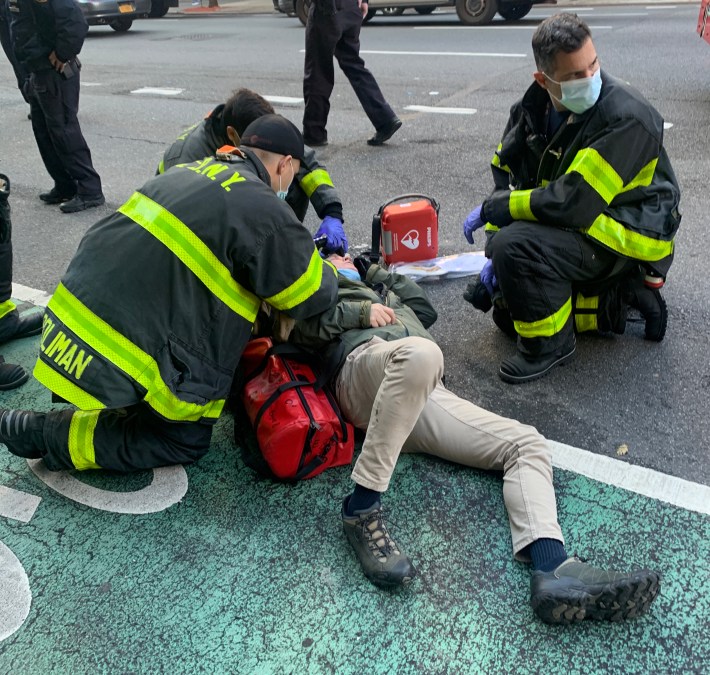 A cyclist is assisted by emergency workers after being struck by a motorist in Manhattan. Photo: Gersh Kuntzman
