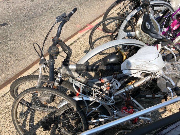 The scene in June, 2019 — after DSNY said it could not remove derelict bikes because they did not meet the criteria. Photo: Stephen Brown