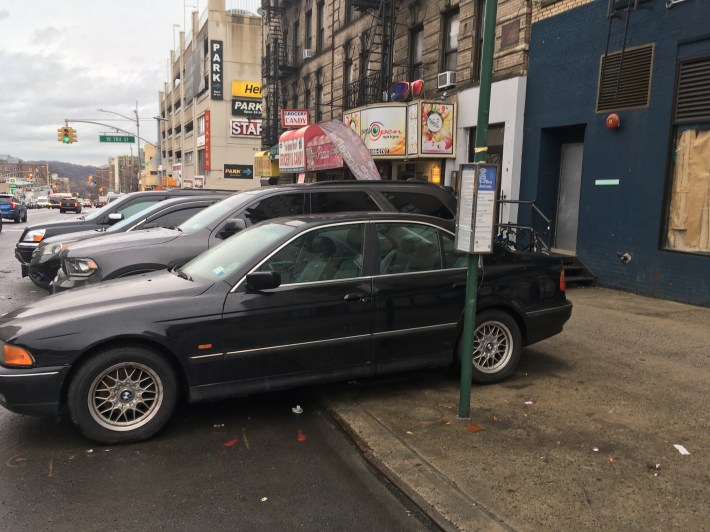 The officers of the 34th Precinct think nothing of inconveniencing bus riders and MTA bus drivers with the careless and illegal way they park their vehicles. Photo: Eve Kessler