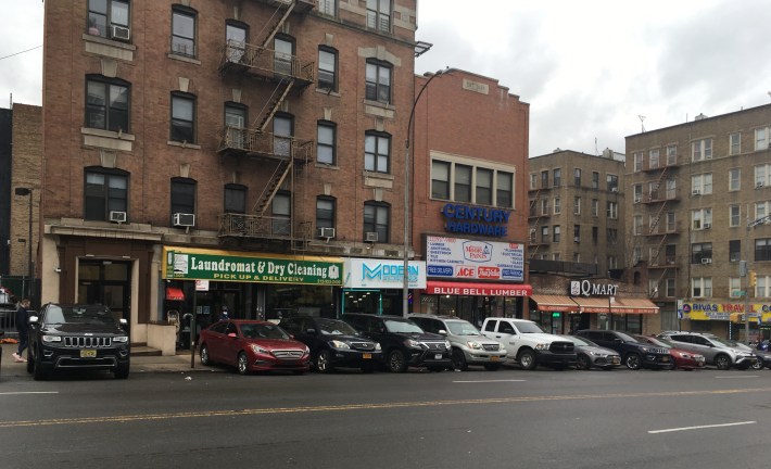 Cars parked on the sidewalk on on the west side of Broadway next to the 34th Precinct. Photo: Eve Kessler