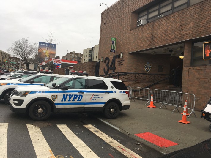 Ugly is as ugly does: Police cruisers parked on the sidewalk in front of the 34th Precinct block egress and hang into the roadway. Photo: Eve Kessler