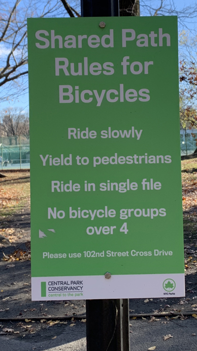 Signs like these are all over Central Park, indicating that cyclists and pedestrians must share a narrow path. Photo: Gersh Kuntzman