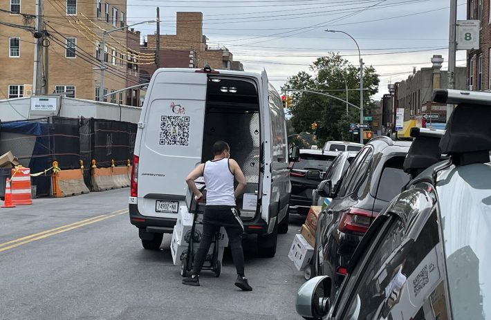 Workers double park to make a delivery, as another driver double parks in front of them. Photo: Dave Colon