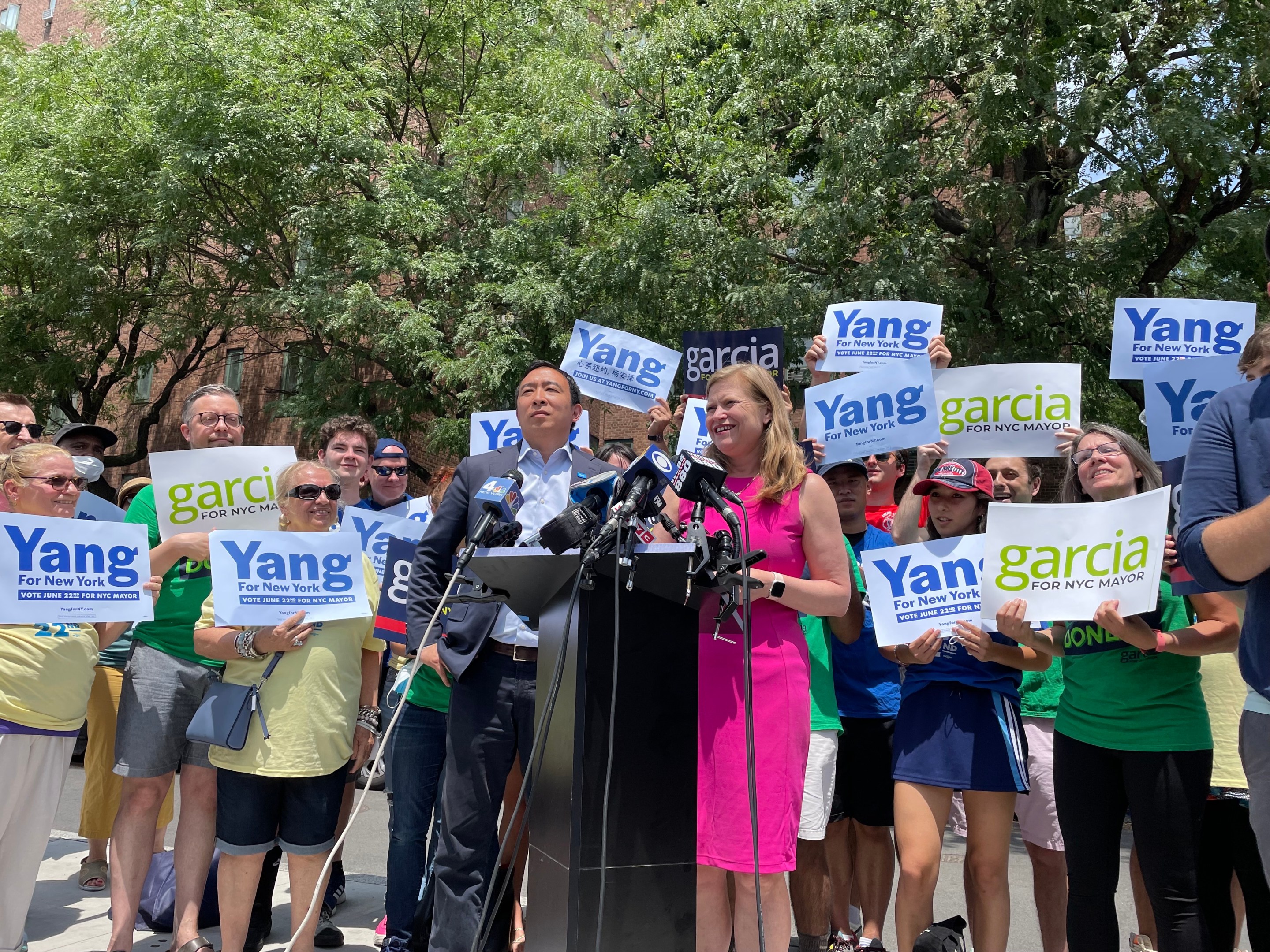 Candidates Andrew Yang and Kathryn Garcia stand side by side behind a podium in Lower Manhattan.