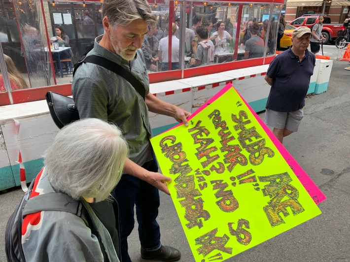 Protest organizer Leif Arntzen with a sign we can't explain. Photo: Tim Donnelly