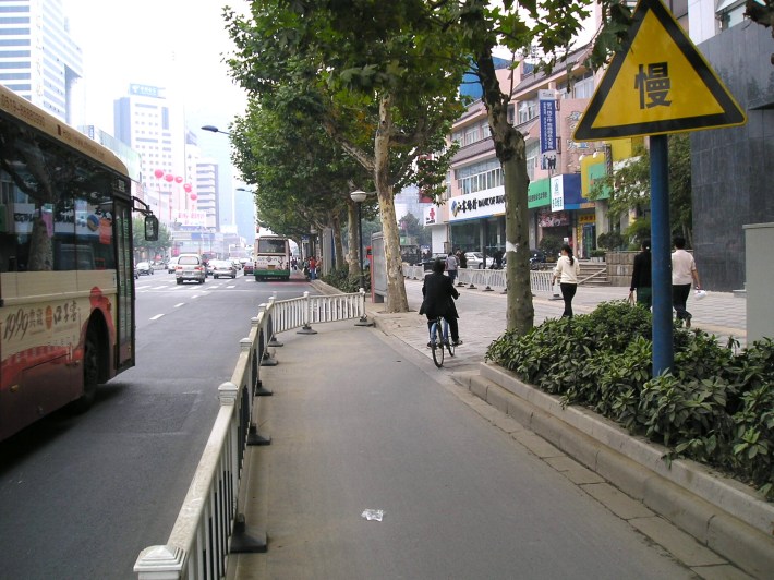 A protected bike lane transitioning to the sidewalk at a bus stop in Changzhou, China. Photo: Michael King