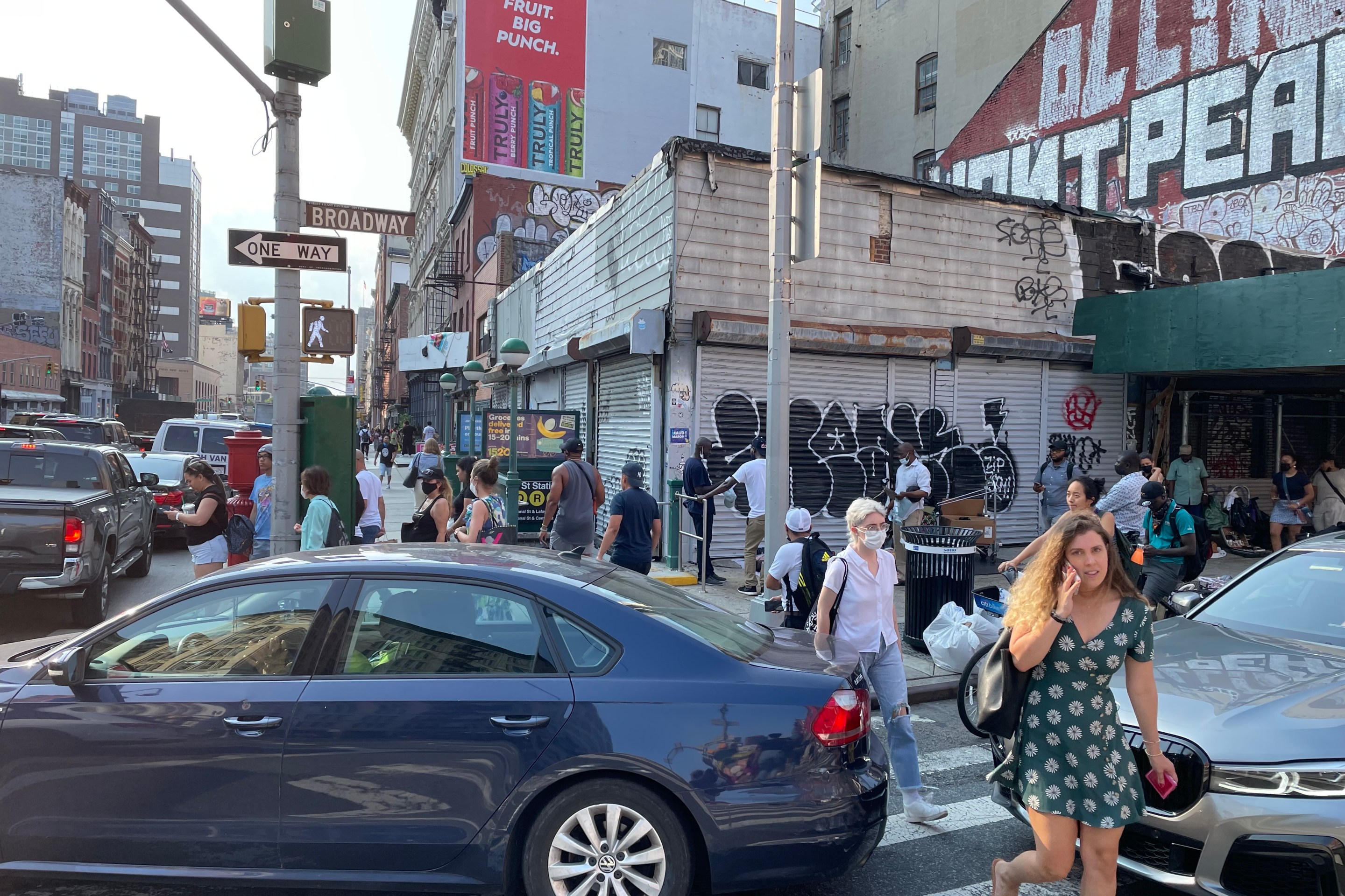 Pedestrians cross a congestion Canal Street.