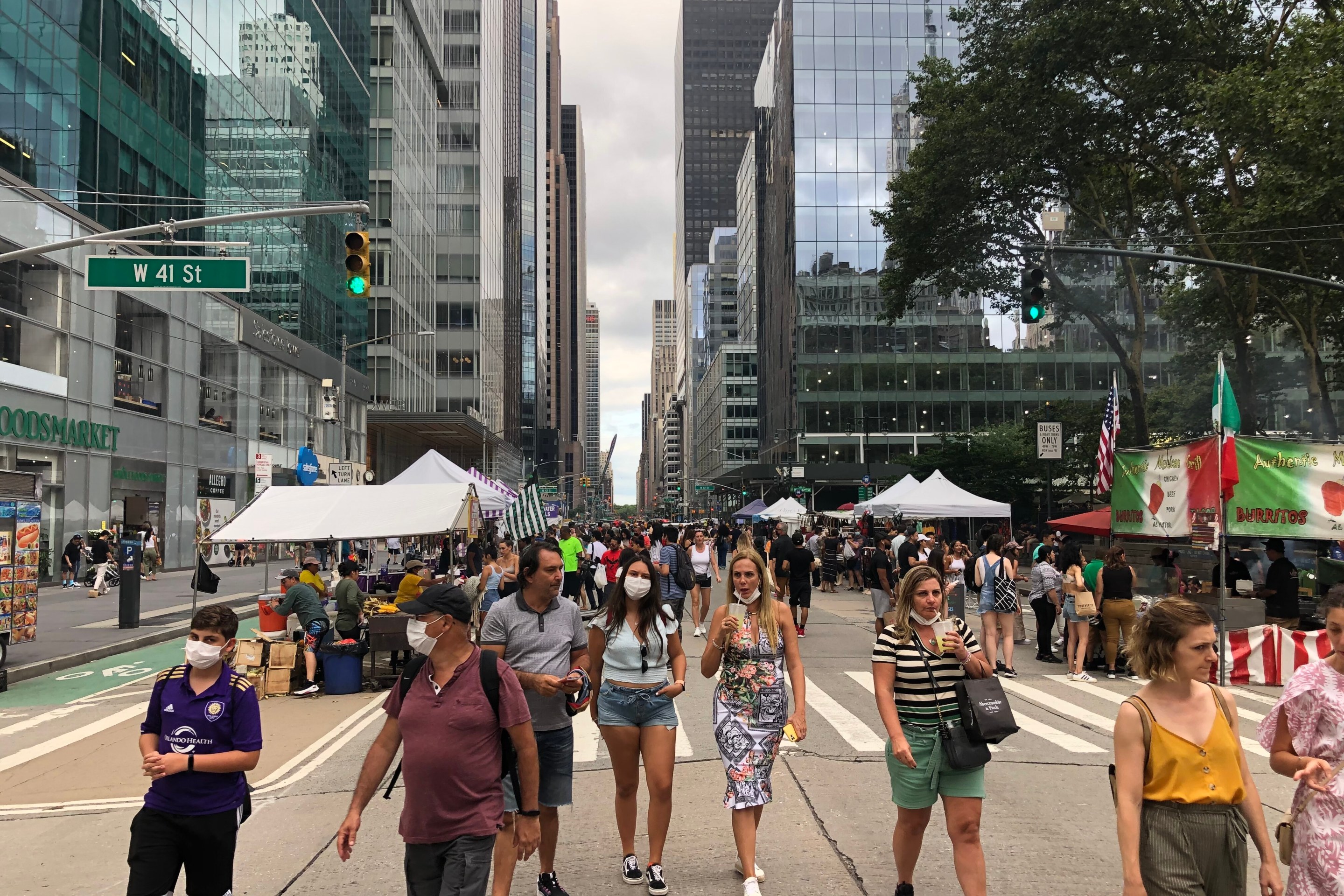 Crowds of people enjoy a street fair on 6th Avenue on July 18th.