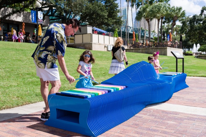 “Why sit when you can play?," a musical public park bench in Tampa, Fla., enables a variety of social-seating interactions. The bench contains two octaves of notes that can be played with attached mallets. Photo: The Urban Conga