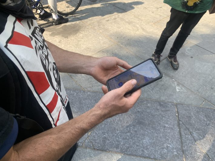 A worker using an app before making a delivery. Photo: Gersh Kuntzman