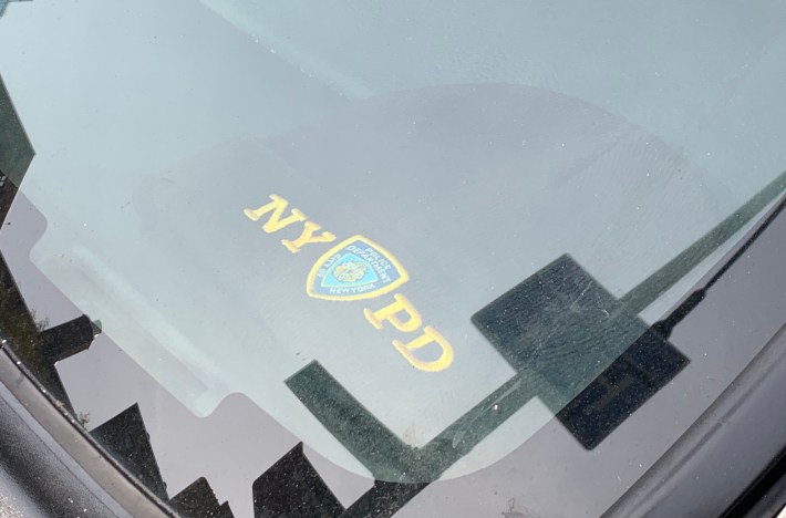 The owner of this car with the NYPD wool cap on the dashboard has Photo: Gersh Kuntzman