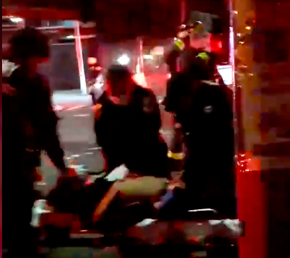 EMTs treating the victim were seen furiously pounding the man's chest. Photo: Citizen