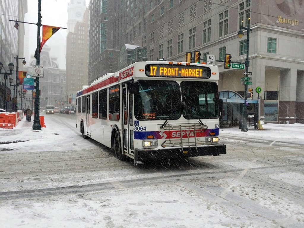 A Philadelphia bus drives through a snowy intersection
