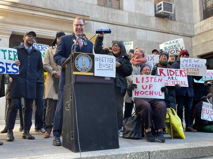 Manhattan Borough President Mark Levine, flanked by a tiny bus, speaks in favor of bus priority projects at Brooklyn Borough Hall. Photo: Dave Colon