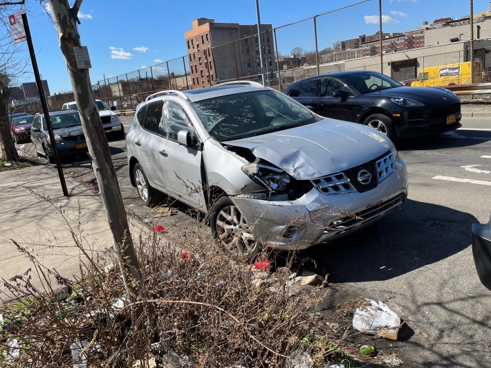 A junked car from a crash investigation, parked next to the 48th Precinct for all to see.
