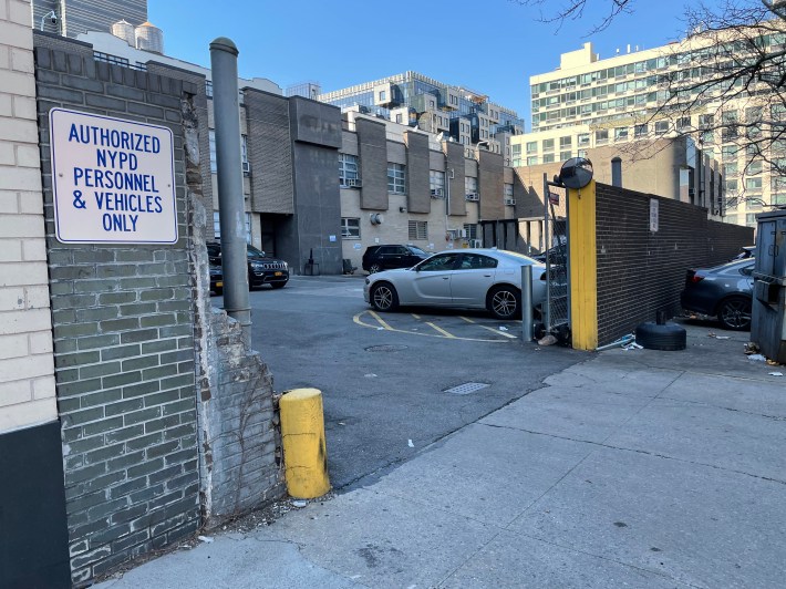 A parking lot for the 84th Precinct to use doesn't stop anyone from parking on the sidewalk.