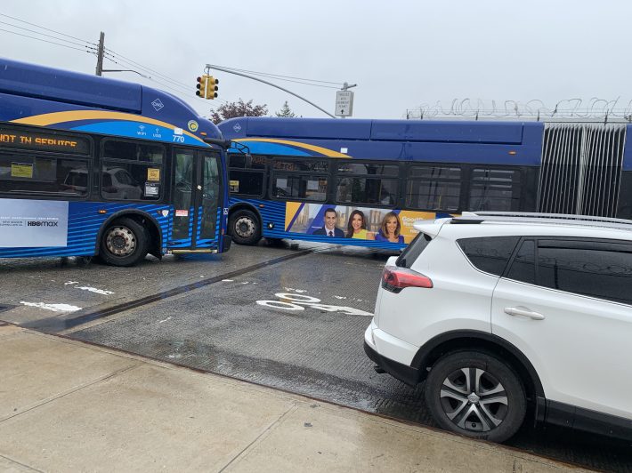 The owner of this NYPD-placard-bearing car that is blocking buses has gotten five speeding tickes since June 2020. Photo: Gersh Kuntzman