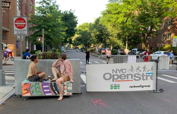 Loungers on 34th Avenue demonstrate the new kind of "hanging out on the stoop." Photo: Gersh Kuntzman