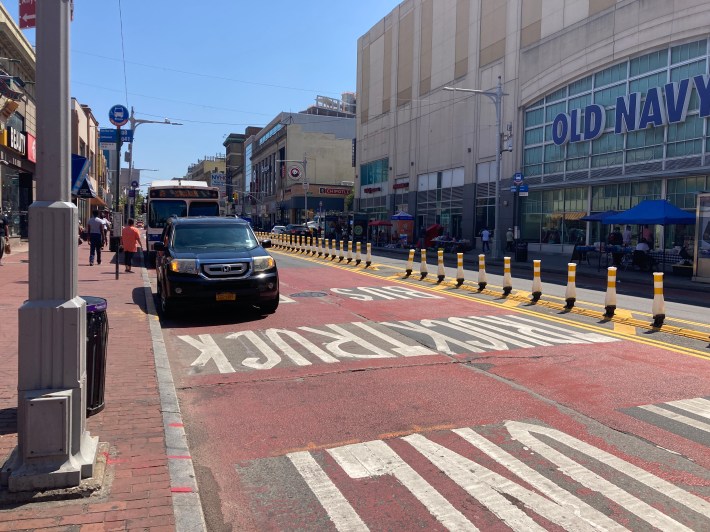 A car blocking the bus lane on Jamaica Avenue. Photo: Julianne Cuba