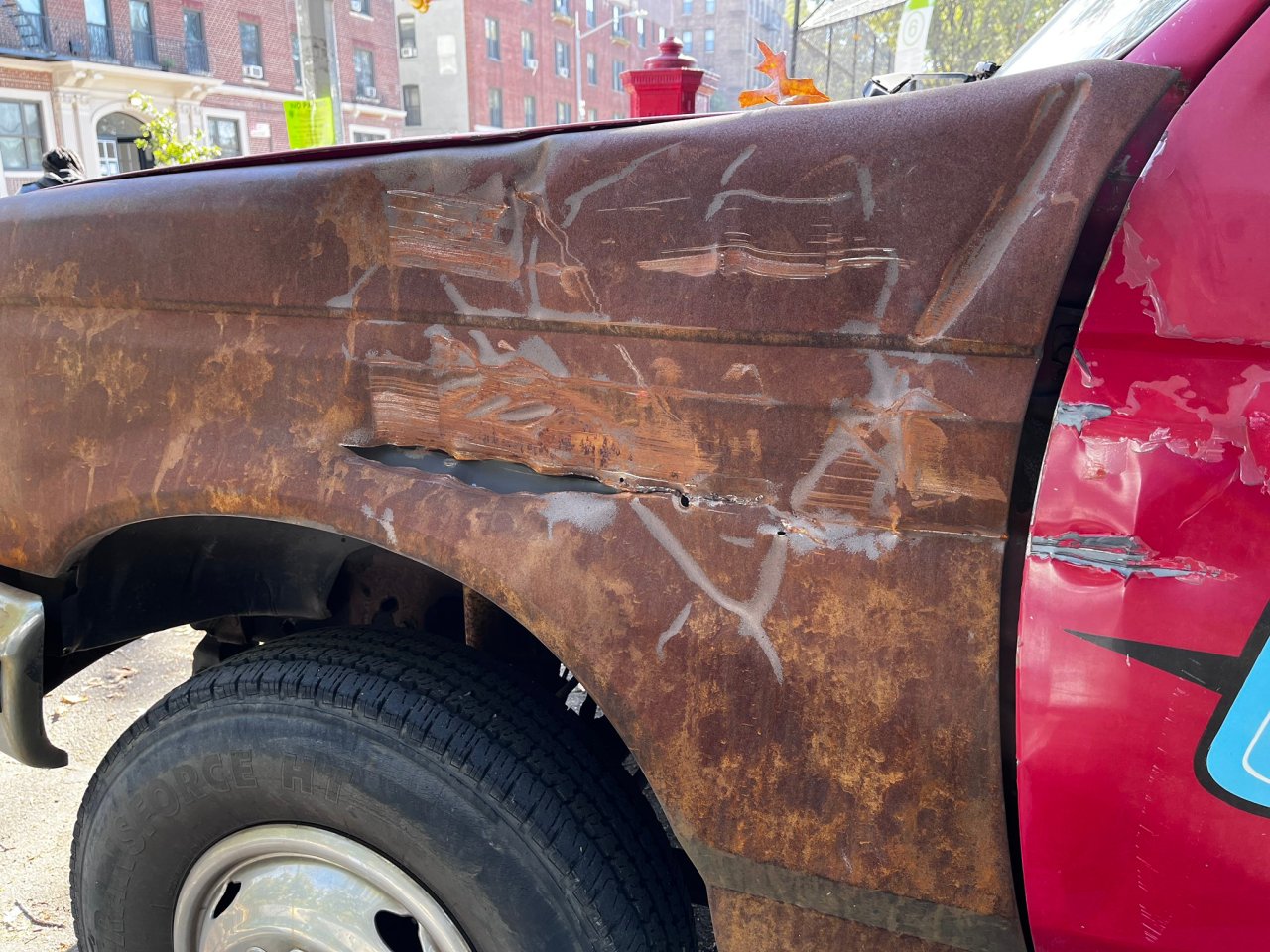If the driver indeed fell off her bike, this scar on a parked truck — at exact handlebar level — would not likely have happened. Photo: Liam Quigley