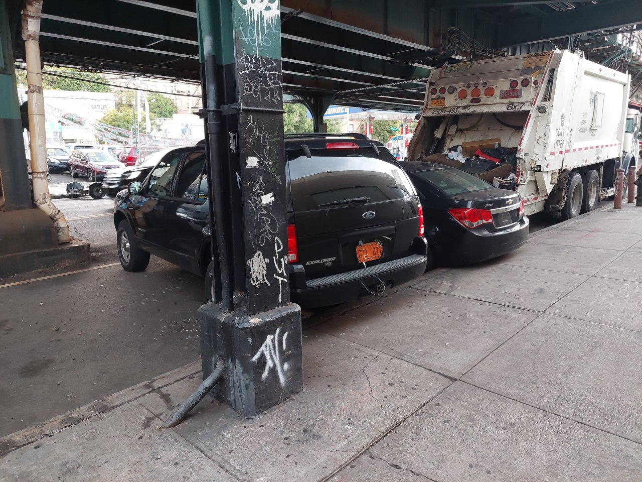 Cars combat parked on 10th Avenue near the DSNY depot at W. 215th Street. Photo: tipster