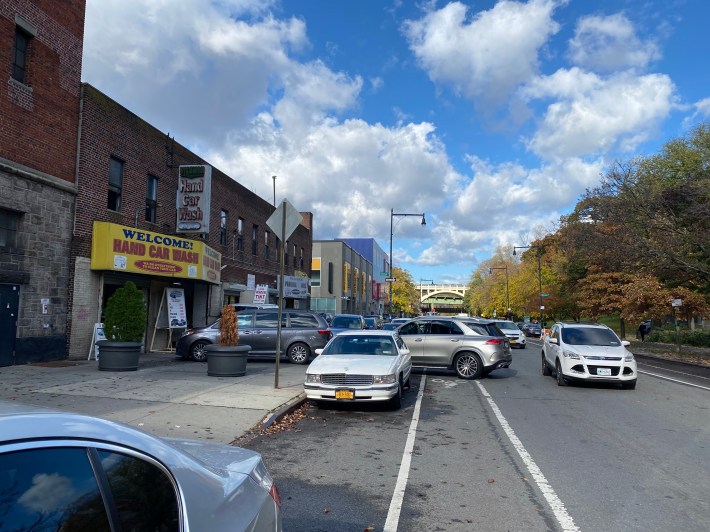The unprotected bike lanes on Dyckman Street were blocked by cars parked outside or lining up at an auto body shop. Photo: Kevin Duggan
