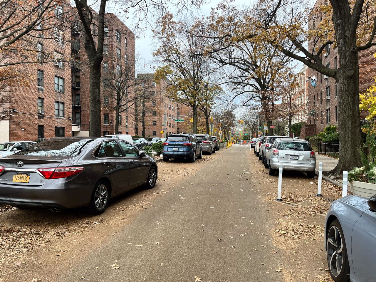 All the cars on the left are illegally parked. Parking on the right side is also illegal, but DOT has not replaced the signs yet. Photo: Tipster
