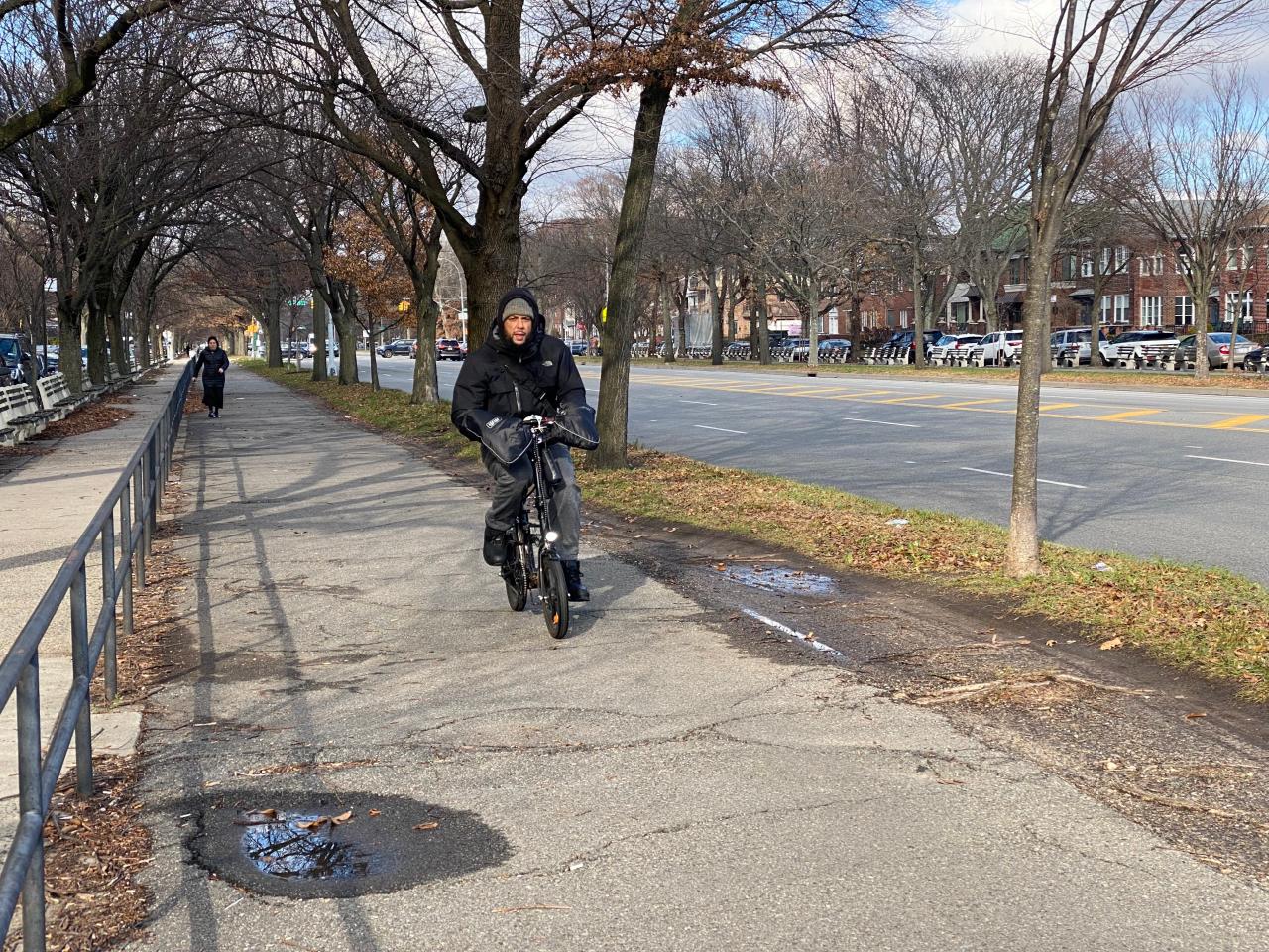 A cyclist on an e-bike rolls over the bumps on Ocean Avenue near Avenue N on Dec. 12. Photo: Kevin Duggan