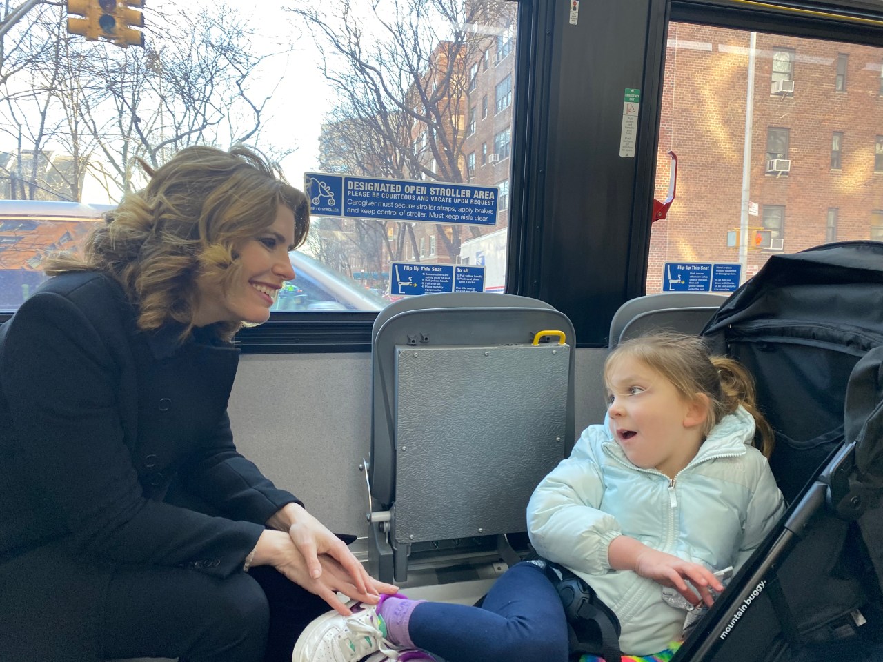 Councilmember Julie Menin and her daughter Maddie, 4, try out the stroller-only area on an MTA bus. Photo: Kevin Duggan.