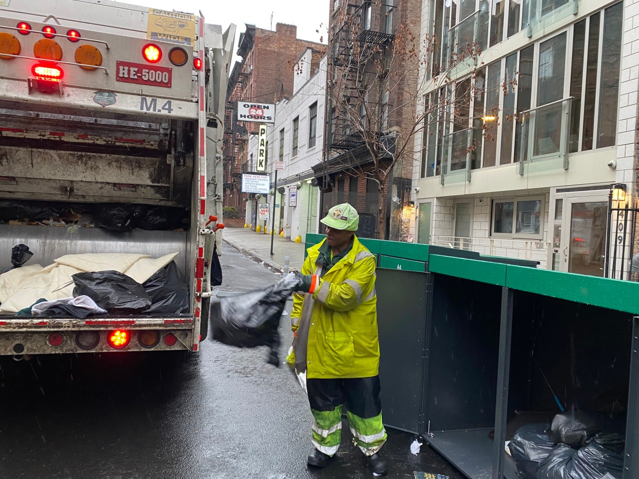 DSNY garbage collector Trevor Evelyn said he got used to the new containerized regime. Photo: Kevin Duggan