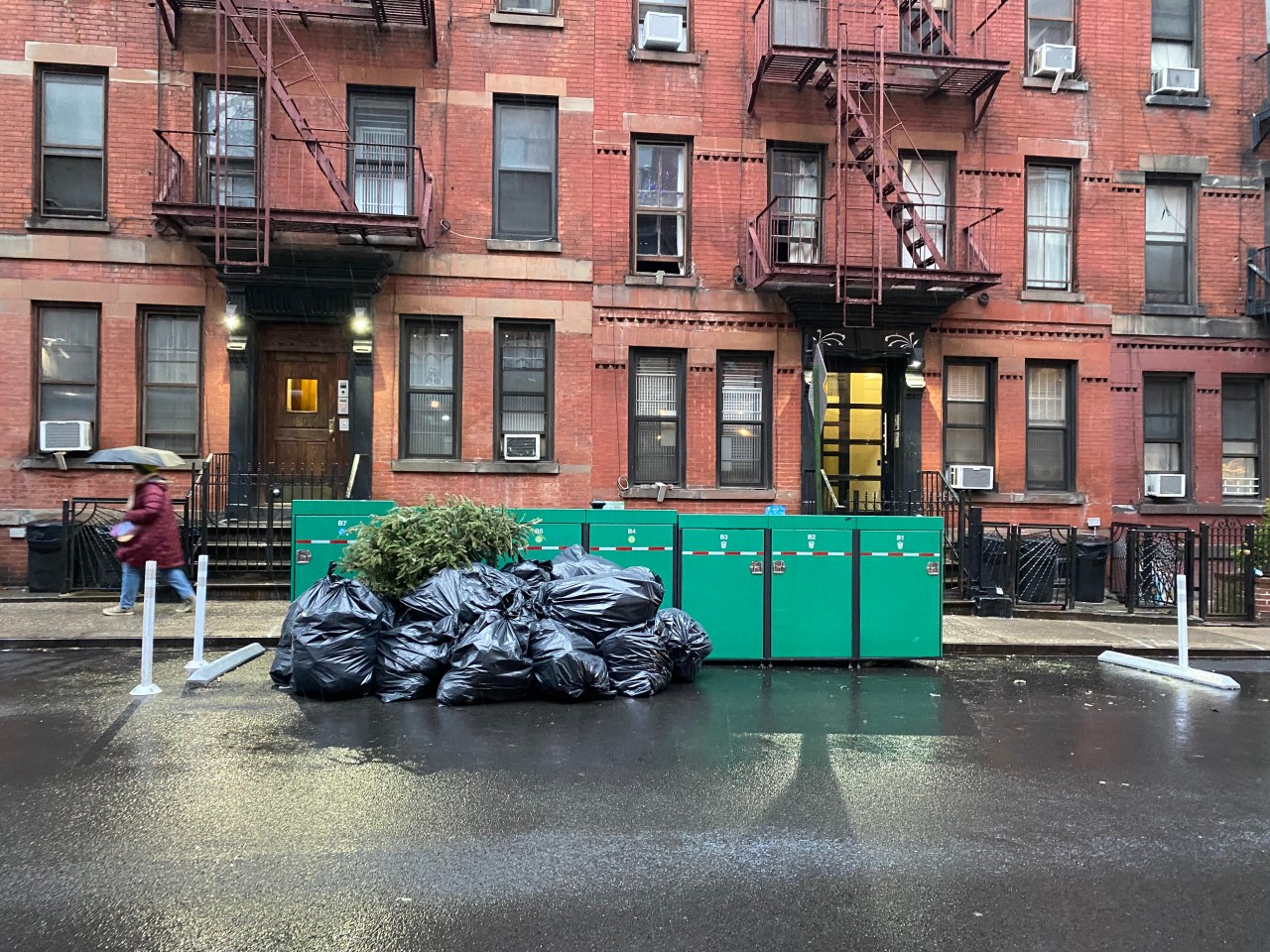 "We overflow a lot," said one super of the bins. DSNY plans to add a dozen more to the block. Photo: Kevin Duggan