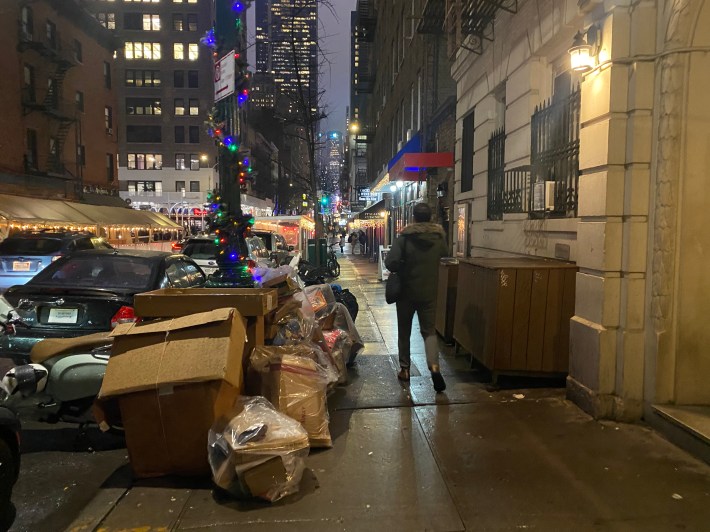 The alternative: Garbage and recycling bags take up space on a nearby Hells Kitchen block on the eve of collection. Photo: Kevin Duggan