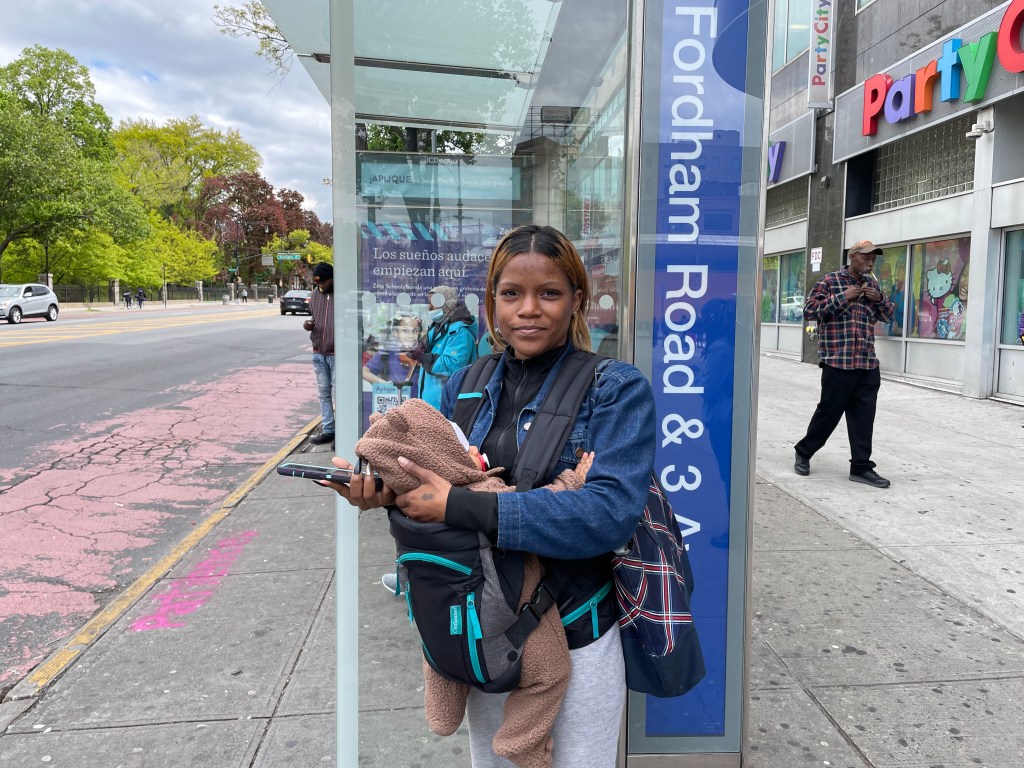 Tynesha Clabornn waits for the bus on Fordham Road with her baby. Photo: Dave Colon